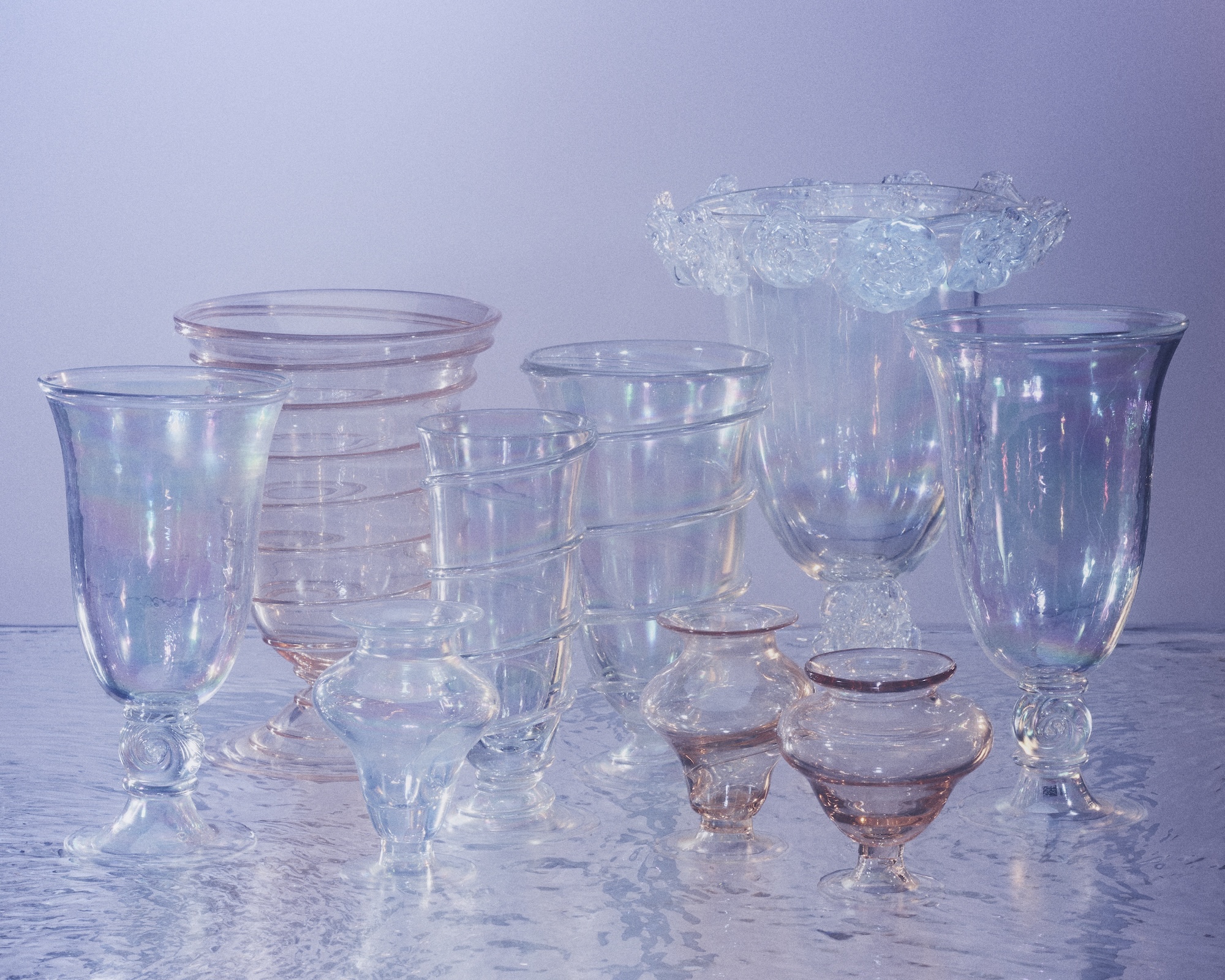 A grouping of iridescent Murano glass vases in varying heights and shapes
