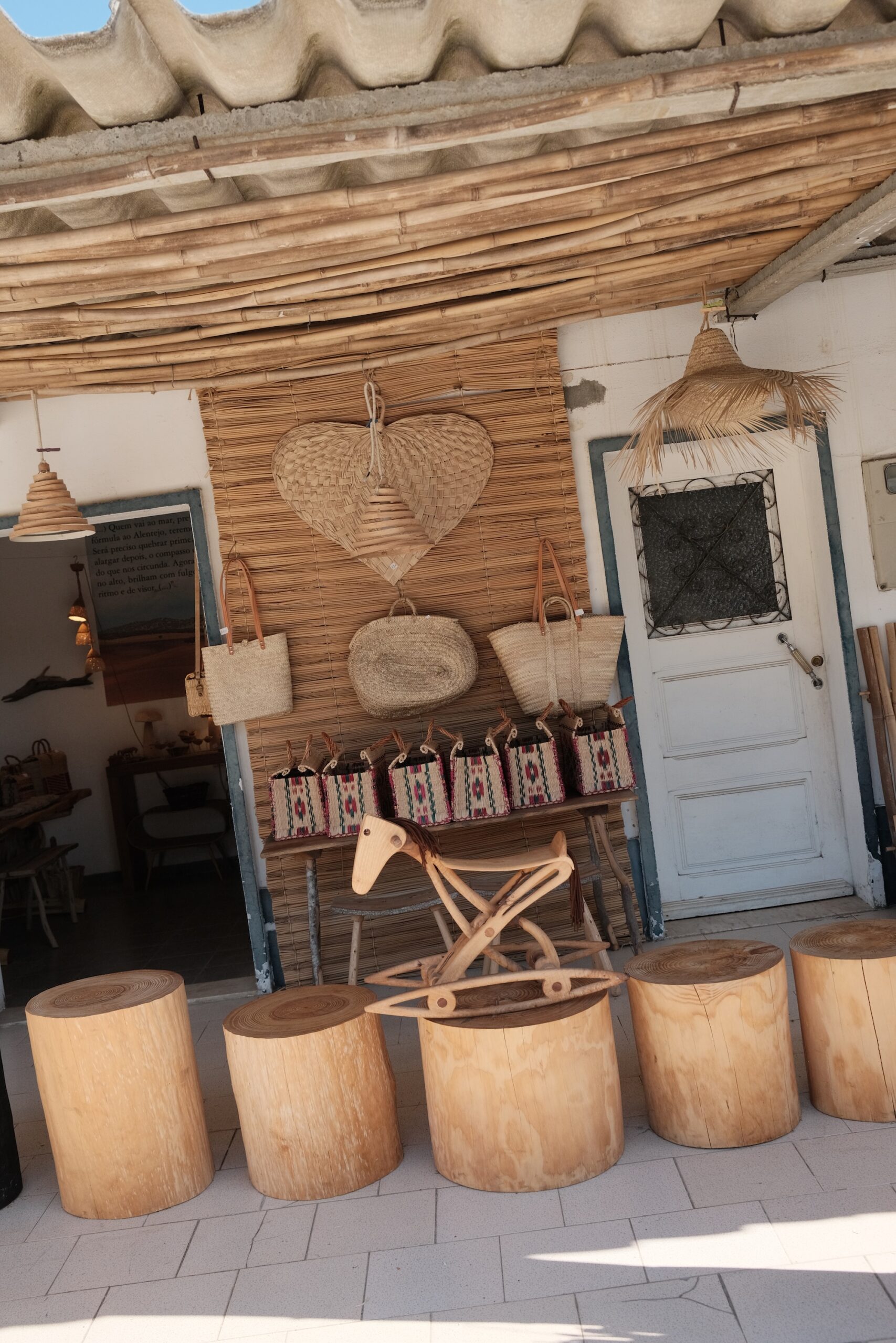 Raffia bags and woven baskets outside Cores da Terra in Melides