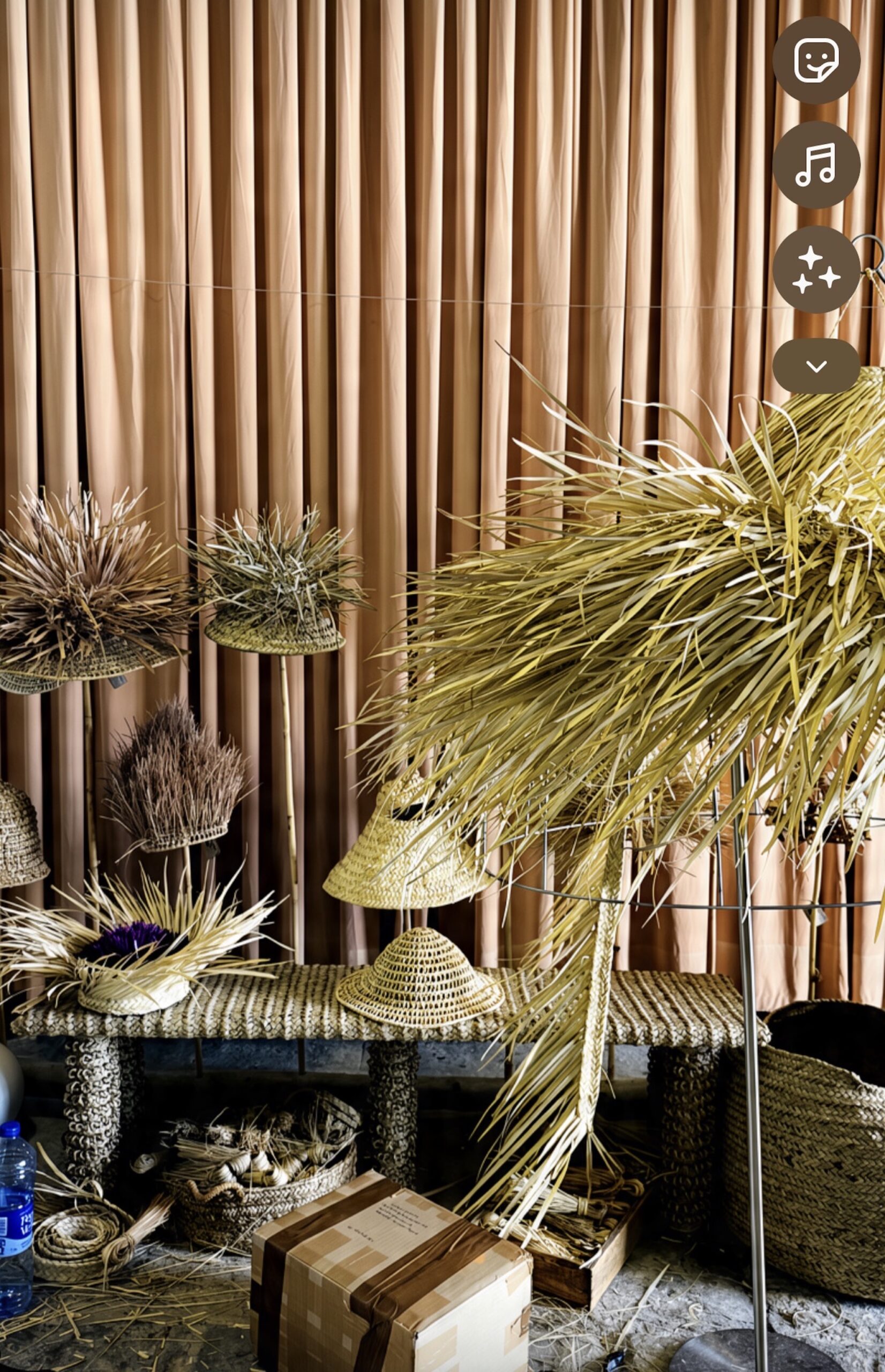 Drying palm leaf bursts on stands in the Palmas Douradas atelier