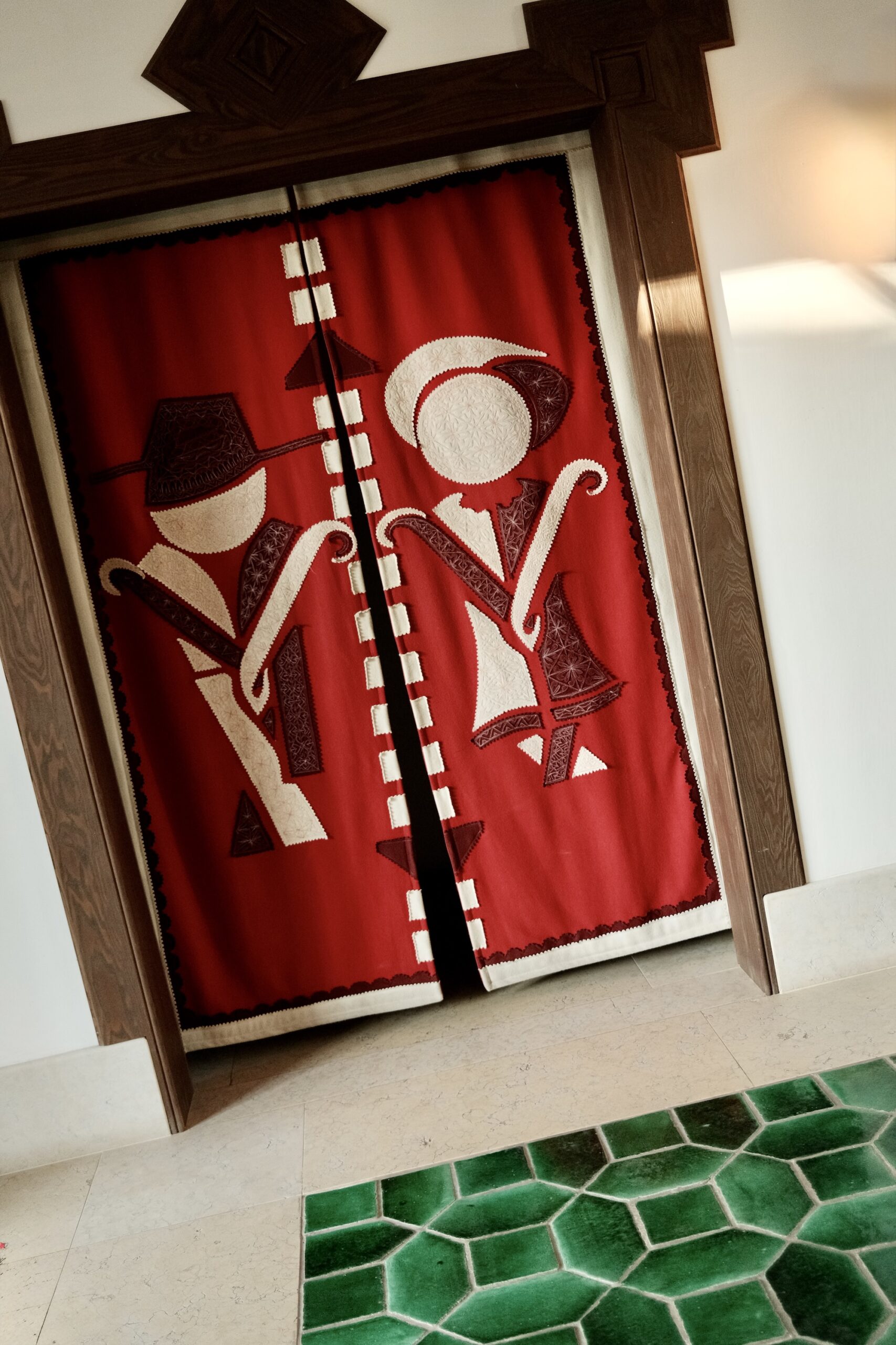A traditional red felt door curtain at Vermelho hotel
