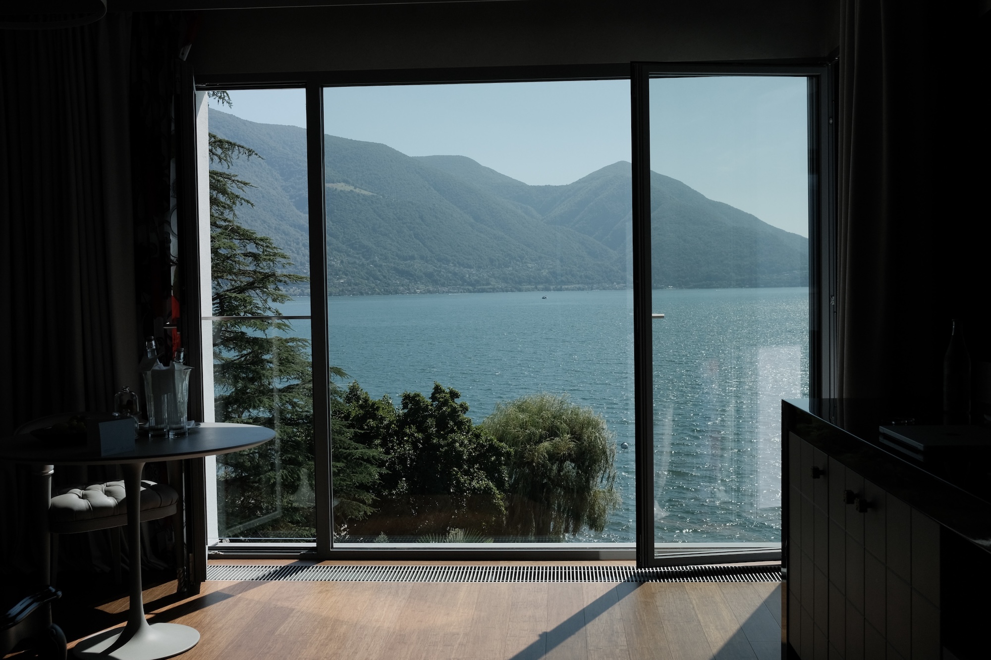 View of Lago Maggiore and the mountains through the room's floor-to-ceiling windows