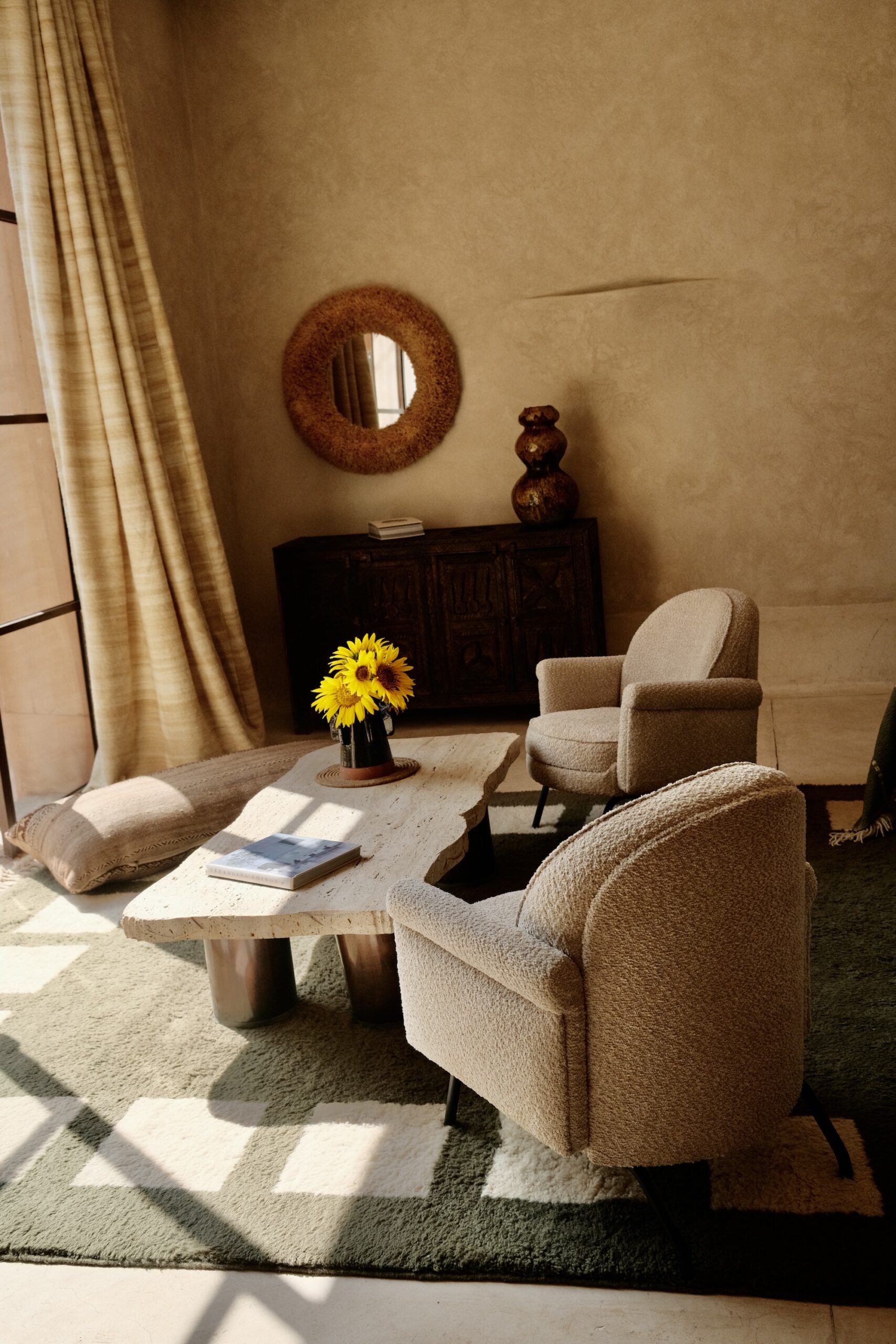 Farasha Farmhouse lounge with armchairs, travertine table and sunflowers